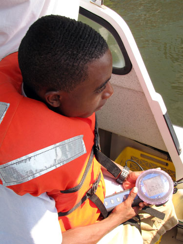 Junior Julian Dubose tests for a suite of water quality parameters, including temperature, Ph, and dissolved oxygen.