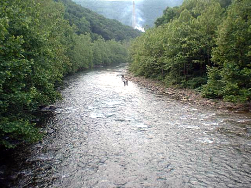 Fly fisherman on the North Branch Potomac with the New Page Paper Mill