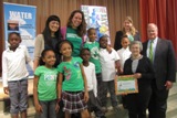 Fourth-graders at John Eager Howard accept certificate for Earth Day poster contest