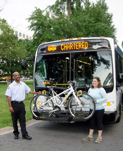 Shannon McDonald of the MDE Water Management Administration tries out one of the bike racks that are on MTA buses. 