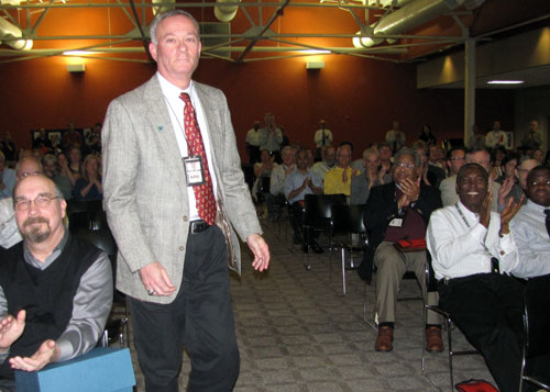 MDE employees applaud as Gary Kelman, who has spearheaded the Department’s efforts to reduce pollution from large animal feeding  