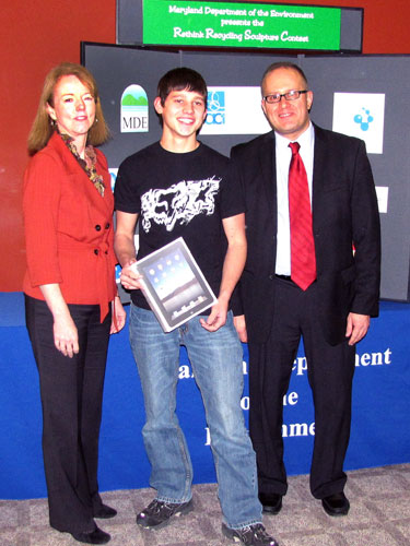 Grand prize winner Josh Tichinel with MDE Secretary Shari T. Wilson and Brian Sansoni of The Cleaning Institute