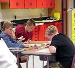 Students_seated_at_table_studying_mining_materials