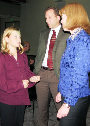  As Employee-of-the-Year finalist Donald (Lee) Currey looks on, Secretary Shari Wilson talks with his daughter, Caroline, 9.