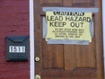 A sign warns of lead abatement work taking place at a residence