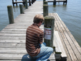 Man posting notice to pier