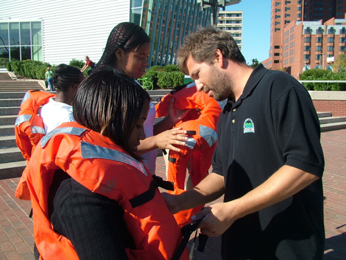 Students from Digital Harbor High School  with MDE's water quality monitoring staff
