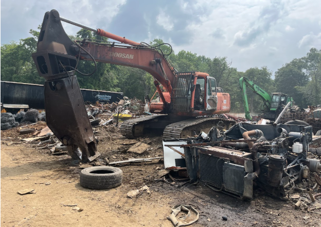 Auto-salvage yard machinery used to move materials. Machinery such as this are sources of oil and grease and subject to BMPs.